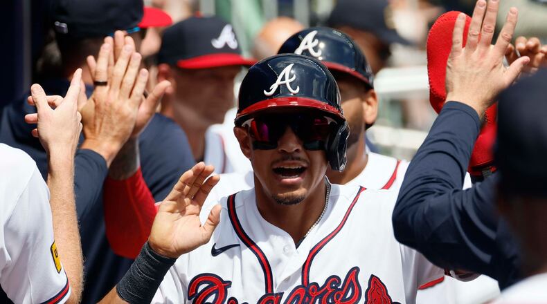 Atlanta Braves' Mauricio Dubón shakes hands with teammates after scoring during the fourth inning against the Athletics at Truist Park on Wednesday, April 1, 2026, in Atlanta. (Miguel Martinez/AJC)