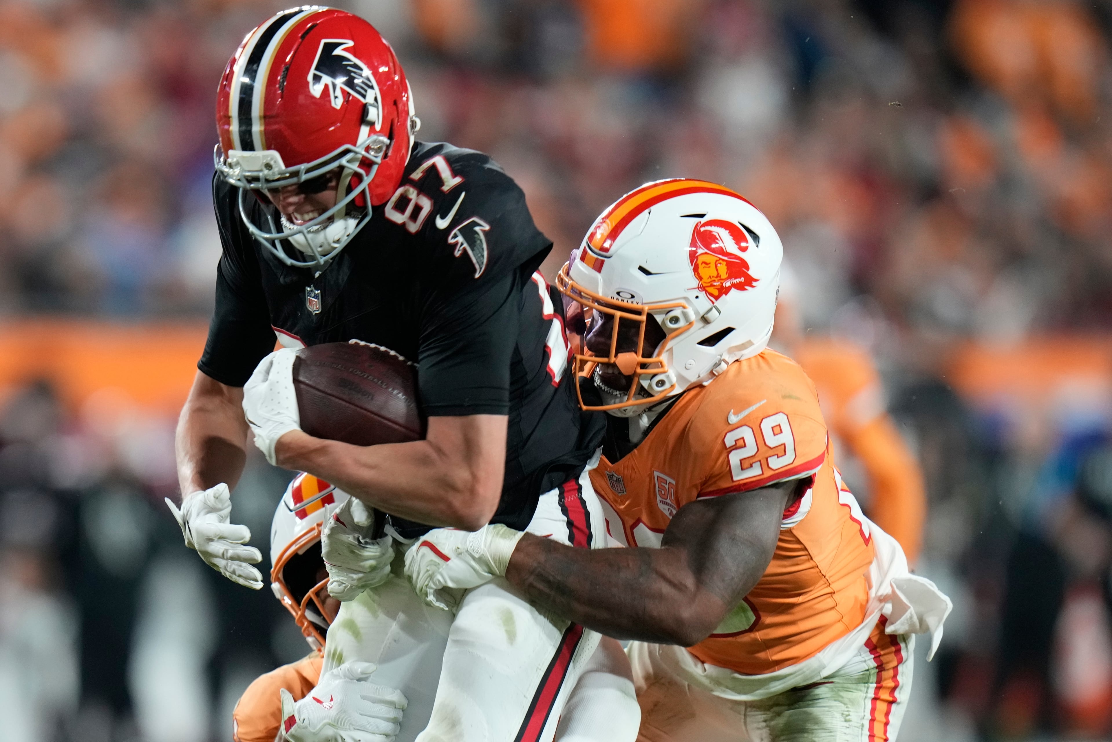 Tampa Bay Buccaneers safety Christian Izien (29) stops Atlanta Falcons wide receiver David Sills V (87) during the second half of an NFL football game, Thursday, Dec. 11, 2025, in Tampa, Fla. (AP Photo/Chris O'Meara)