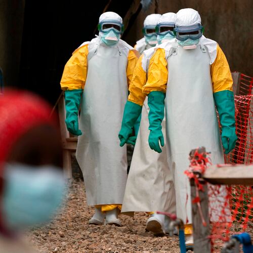 FILE - Health workers dressed in protective gear begin their shift at an Ebola treatment center in Beni, Congo, July 16, 2019. (AP Photo/Jerome Delay, File)