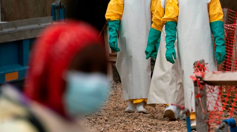 FILE - Health workers dressed in protective gear begin their shift at an Ebola treatment center in Beni, Congo, July 16, 2019. (AP Photo/Jerome Delay, File)