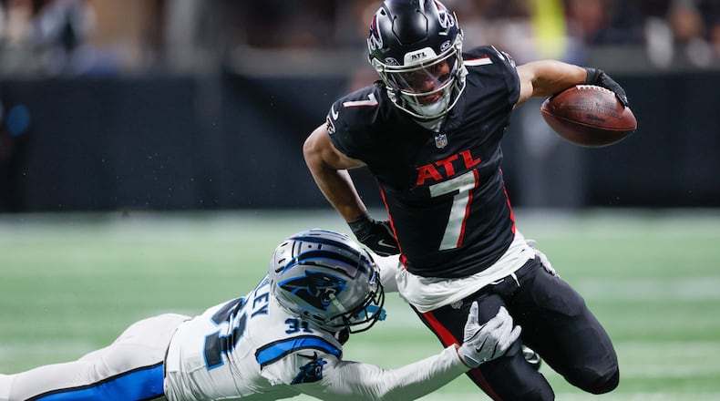 Atlanta Falcons running back Bijan Robinson (7) runs for yards against Carolina Panthers cornerback Caleb Farley (31) during an NFL football game January 5, 2025, at Mercedes-Benz Stadium in Atlanta.  (Miguel Martinez/AJC)