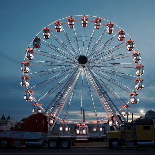 The ferris wheel on the National Mall is lit as preparation continues for the Great American State Fair on the National Mall, Sunday, June 21, 2026, in Washington. (AP Photo/Jon Elswick