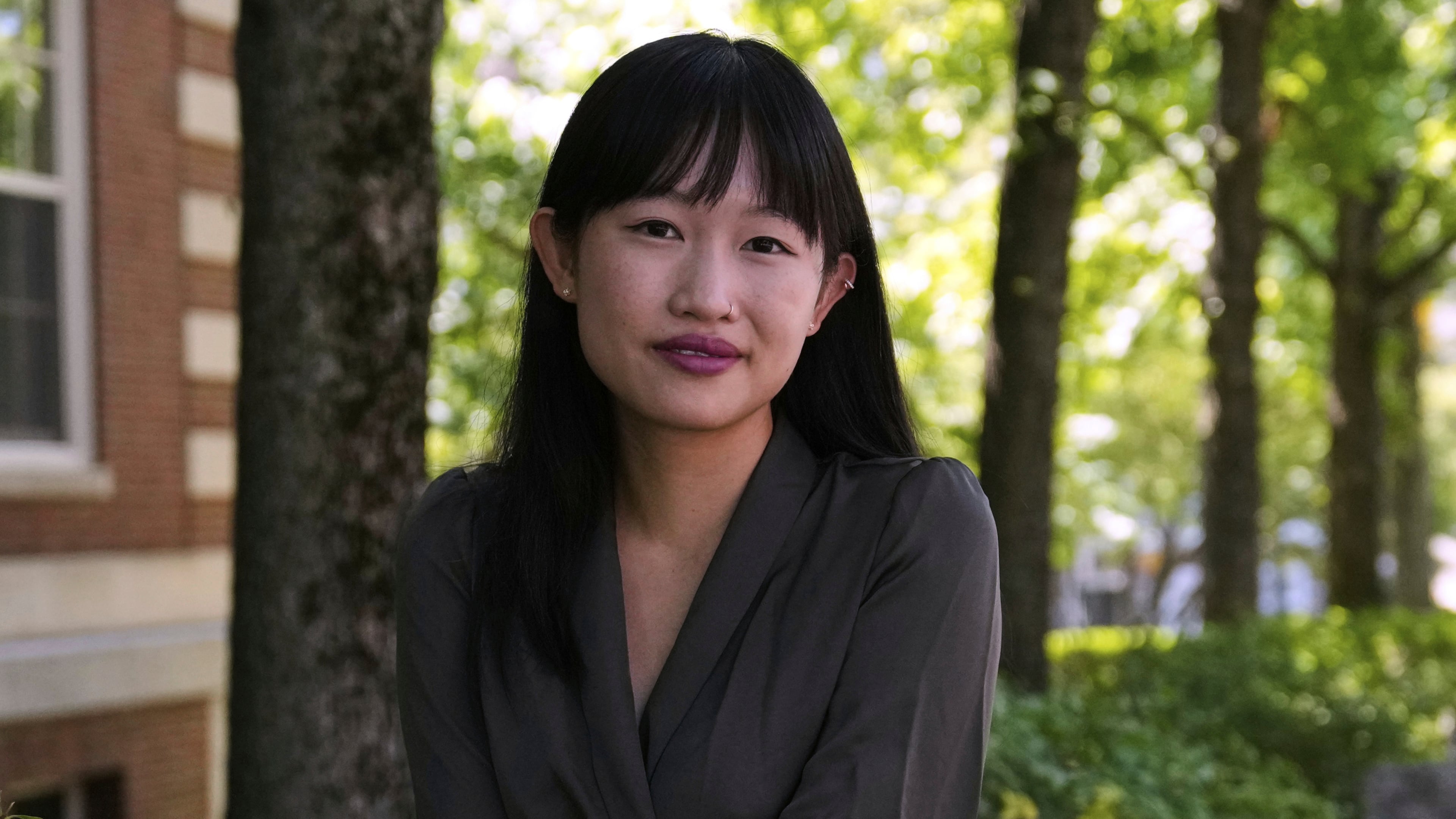 FILE - Author R.F. Kuang poses for a portrait near Harvard University in Cambridge, Mass., on Monday, July 28, 2025. (AP Photo/Charles Krupa, File)