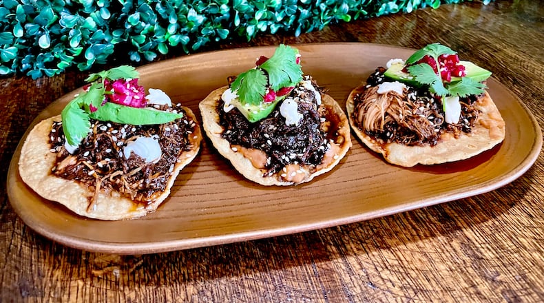 Delivered on three crisp, house-made tostadas, Patria Cocina’s tostadas de mole negro can be an appetizer or an entree. (Angela Hansberger for The Atlanta Journal-Constitution)