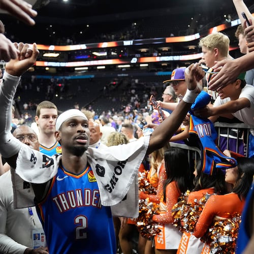 Oklahoma City Thunder guard Shai Gilgeous-Alexander celebrates with fans after Game 4 in a first-round NBA playoffs basketball series against the Phoenix Suns, Monday, April 27, 2026, in Phoenix. (AP Photo/Ross D. Franklin)
