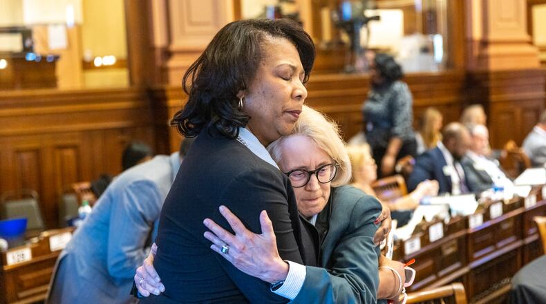 (L-R) State Rep. Debra Bazemore, D-South Fulton, embraces Rep. Karla Drenner, D-Avondale Estates, who was the first openly gay member of the Georgia legislature, after Drenner spoke against SB 140 at the House of Representatives on Thursday, March 16, 2023. SB 140 limits treatment for transgender youth. (Arvin Temkar / arvin.temkar@ajc.com)