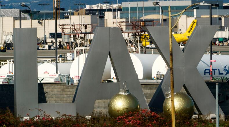 FILE - Air traffic is seen on the runway at Los Angeles International Airport on Sunday, Dec. 25, 2022. (AP Photo/Damian Dovarganes, File)