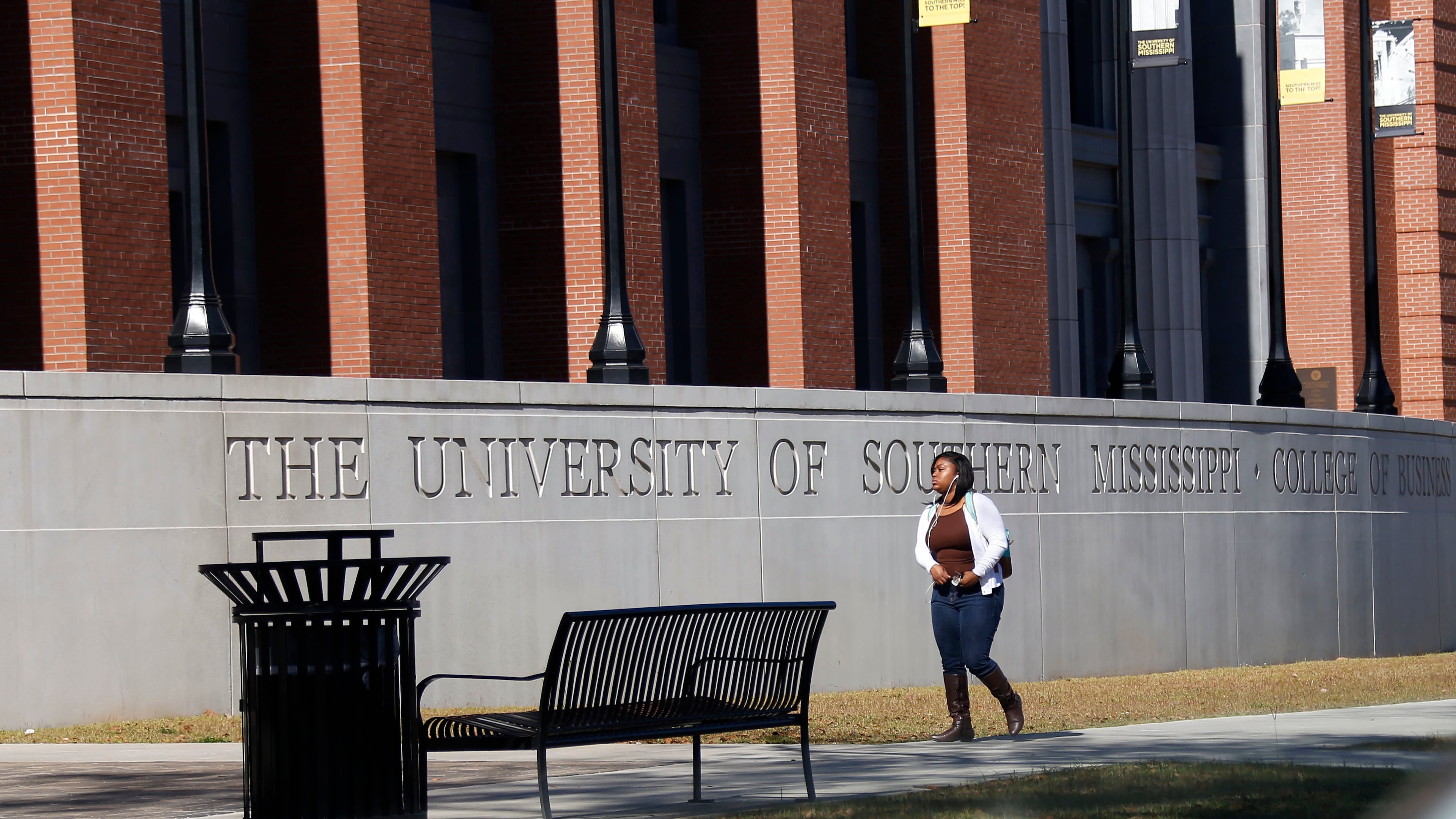 FILE - A student walks across the University of Southern Mississippi School of Business in Hattiesburg, Miss., Nov. 21, 2016. (AP Photo/Rogelio V. Solis, File)