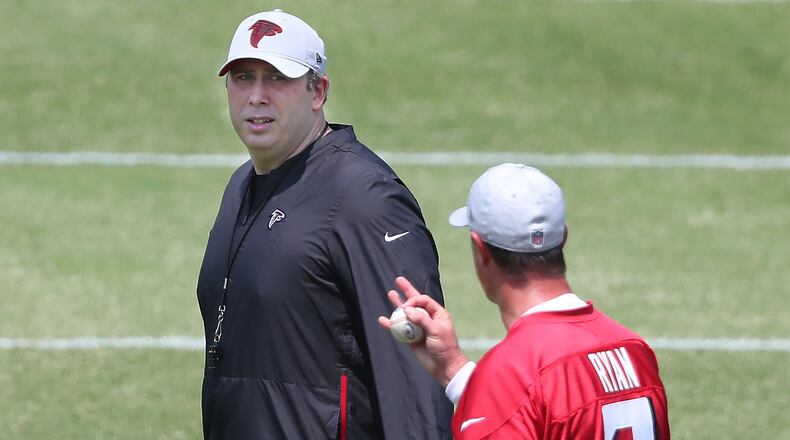 Falcons head coach Arthur Smith (left) speaks with quarterback Matt Ryan during organize team activities (OTAs) Tuesday, May 25, 2021, at the team training facility in Flowery Branch. (Curtis Compton / Curtis.Compton@ajc.com)