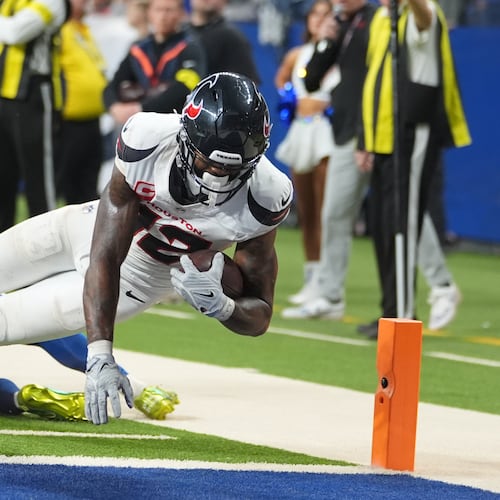 Houston Texans' Nico Collins (12) scores a touchdown against the Indianapolis Colts during the second half of an NFL football game Sunday, Nov. 30, 2025, in Indianapolis. (AP Photo/Michael Conroy)