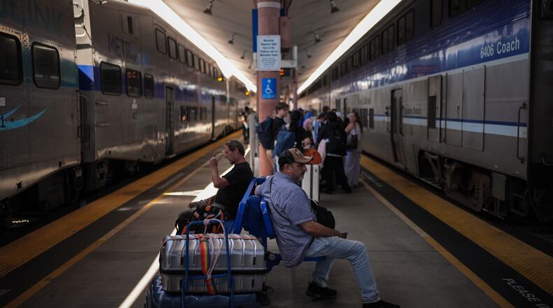 Travelers wait to board an Amtrak train at Union Station in Los Angeles, Wednesday, May 20, 2026. (AP Photo/Jae C. Hong)