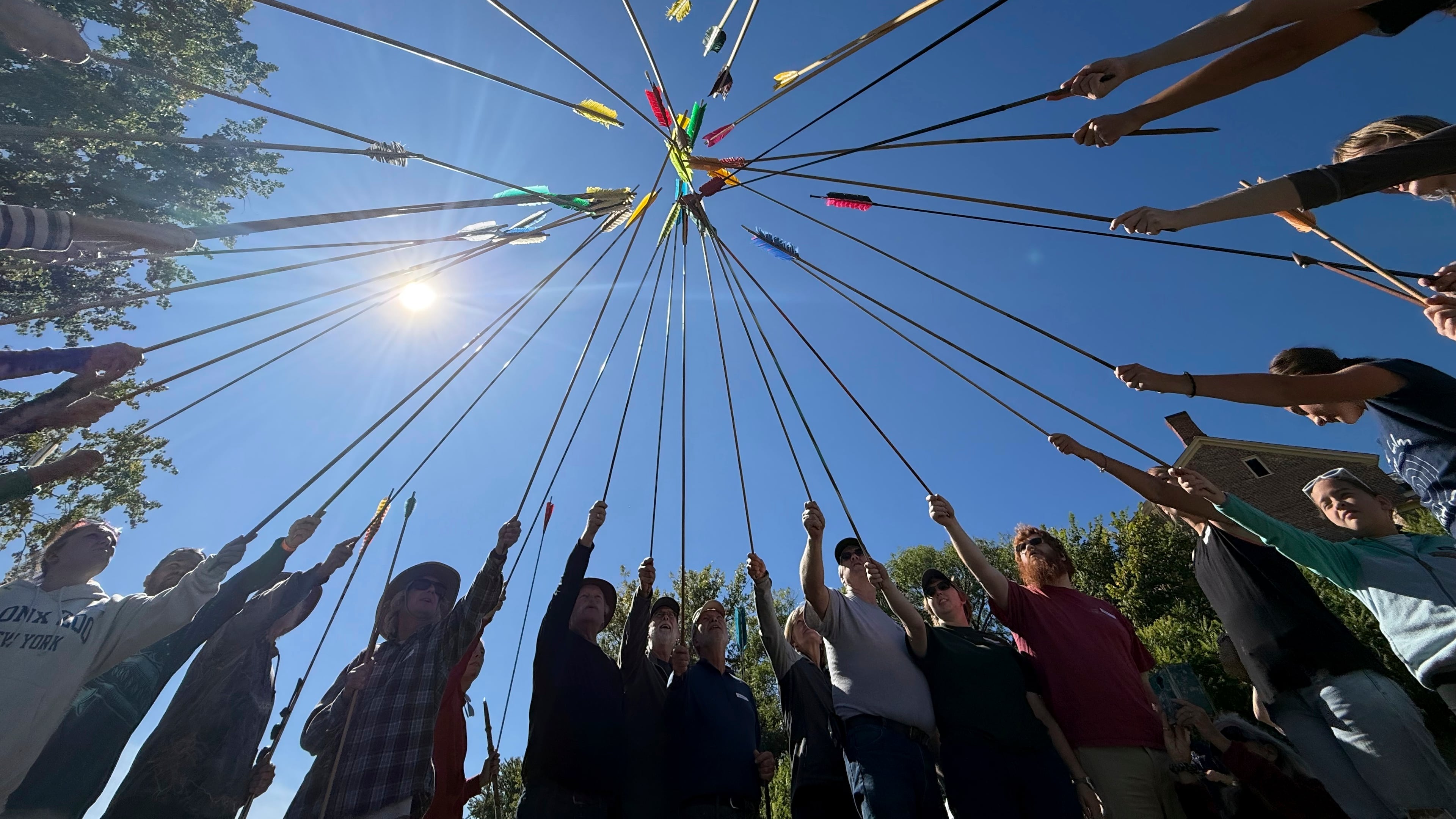 Competitors raise their darts as part of the opening ceremony for the Northeastern Atlatl Championship in Addison, Vt., Saturday, Sept. 20, 2025. (AP Photo/Amanda Swinhart)