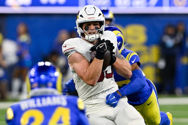 FILE - Arizona Cardinals tight end Trey McBride (85) makes a catch while Los Angeles Rams safety Quentin Lake tackles him during the first half of an NFL football game Saturday, Dec. 28, 2024, in Inglewood, Calif. (AP Photo/Alex Gallardo, File)