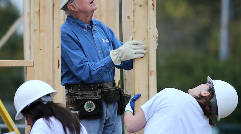 Former President Jimmy Carter helps position an exterior wall while working on a Habitat for Humanity build November 2015 in Memphis. Ben Gray / bgray@ajc.com