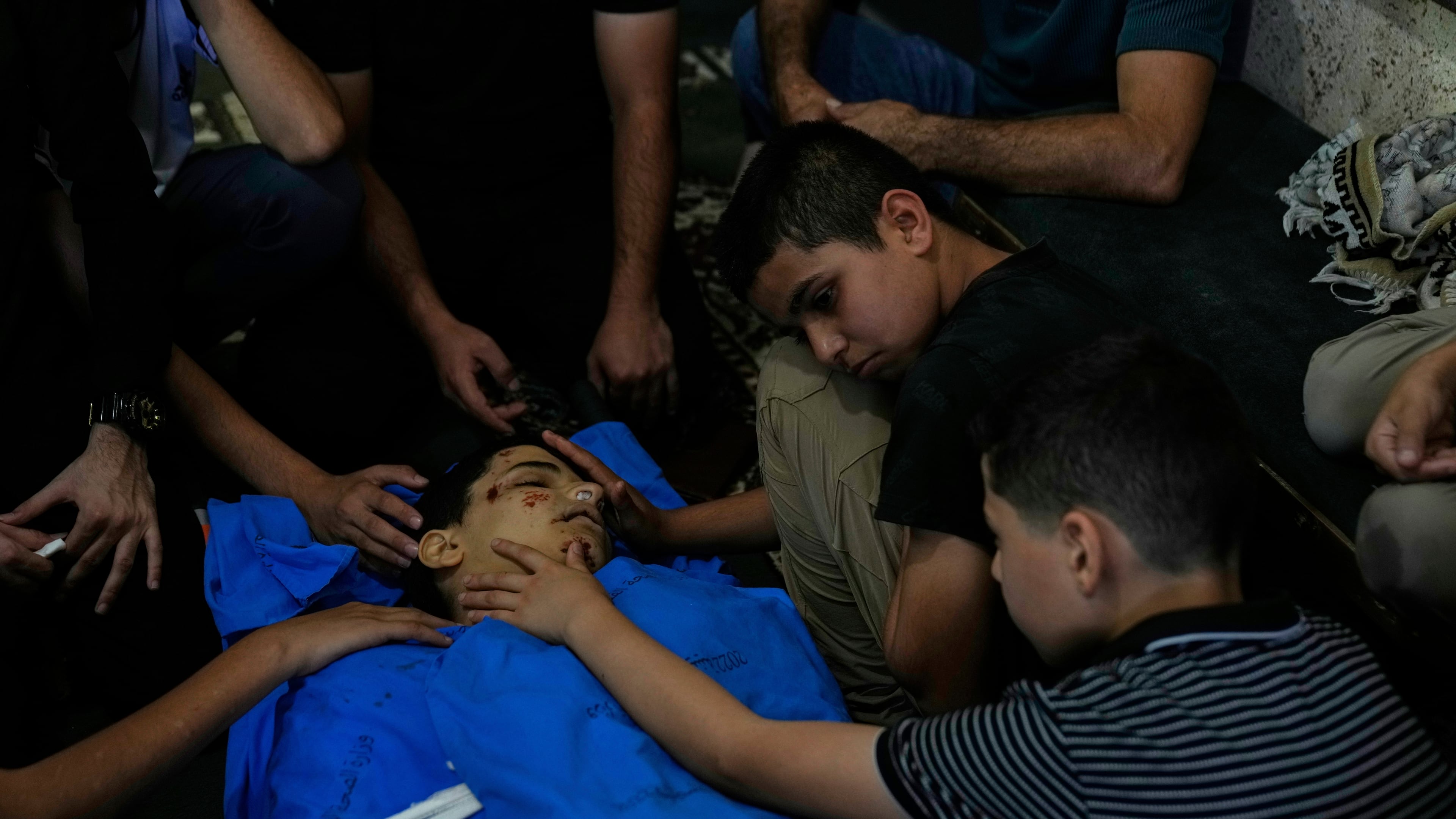 Qassam, 11, center takes the last look at his brother Islam Majarmeh, one of two 14-year-old Palestinian boys who were killed in the Jenin refugee camp on Monday, during his funeral in the Israeli occupied West Bank city of Jenin Tuesday, Sept. 9, 2025. (AP Photo/Nasser Nasser)