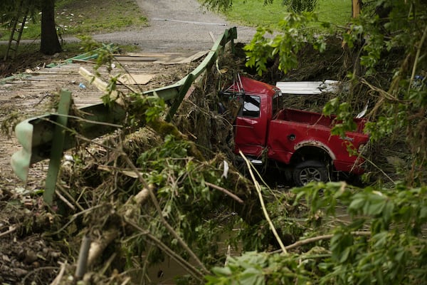 A vehicle sits in flood debris, Monday, June 16, 2025, in Valley Grove, W.Va. (AP Photo/Carolyn Kaster)