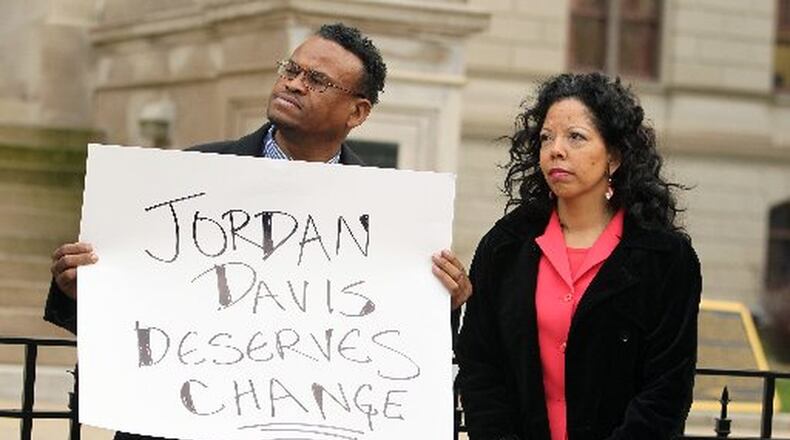 Lucy McBath (right), the mother of shooting victim Jordan Davis, stands next to Quincy Harris, of Atlanta, before McBath spoke at an Atlanta gun control rally on the west side steps of the Capitol two years ago. Jordan Davis was killed in 2012 in Florida during a dispute over loud music. AJC FILE PHOTO