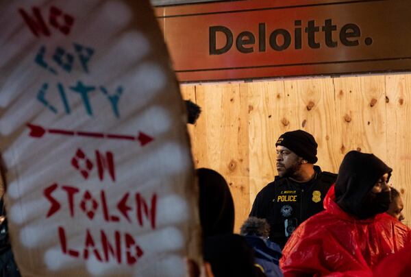 Atlanta police guard the front of the office building where the Atlanta Police Foundation has an office as protesters against a public safety training center rally on Thursday, March 9, 2023. (Photo: Ben Gray for The Atlanta Journal-Constitution)
