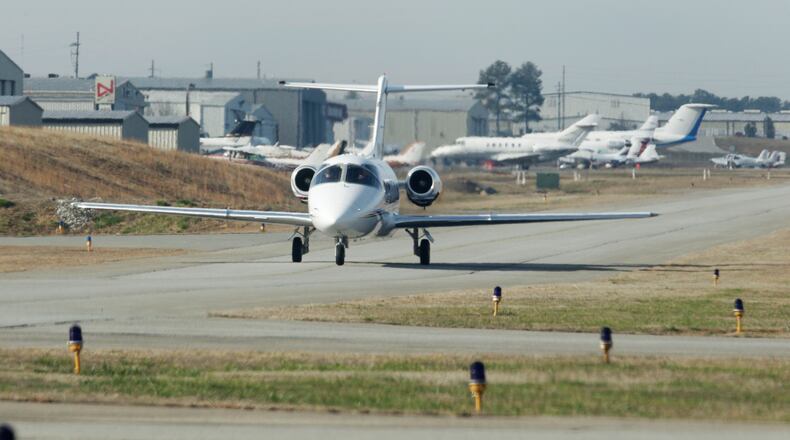 A small jet aircraft moves on the runway at Briscoe Field.