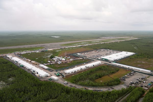 Work progresses on a new migrant detention facility dubbed "Alligator Alcatraz," at Dade-Collier Training and Transition facility in the Florida Everglades, Friday, July 4, 2025, in Ochopee, Fla. (AP Photo/Rebecca Blackwell)
