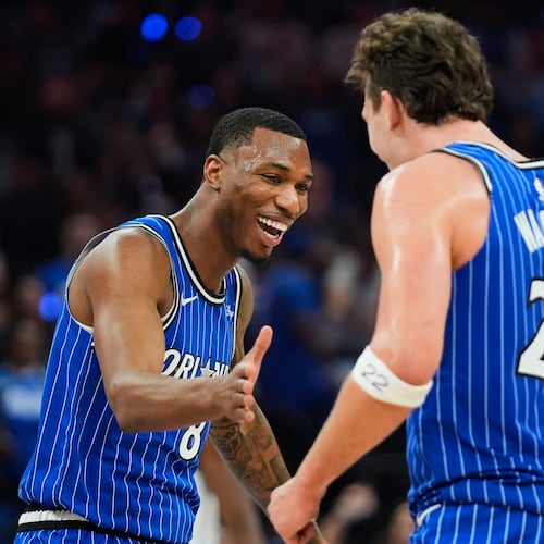 Orlando Magic forward Jamal Cain, left, celebrates a big play against the Charlotte Hornets with forward Franz Wagner (22) during the second half of an NBA play-in tournament basketball game, Friday, April 17, 2026, in Orlando, Fla. (AP Photo/John Raoux)