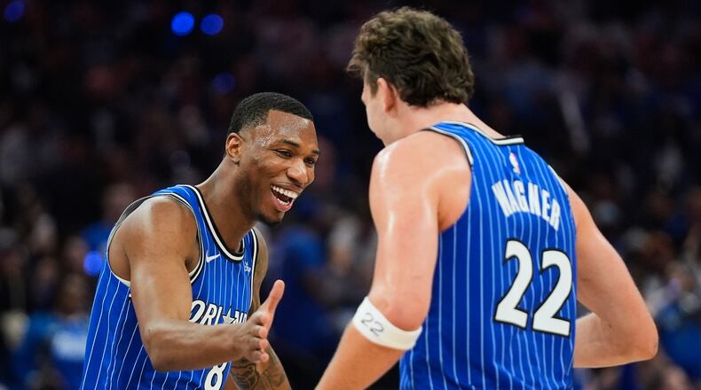 Orlando Magic forward Jamal Cain, left, celebrates a big play against the Charlotte Hornets with forward Franz Wagner (22) during the second half of an NBA play-in tournament basketball game, Friday, April 17, 2026, in Orlando, Fla. (AP Photo/John Raoux)