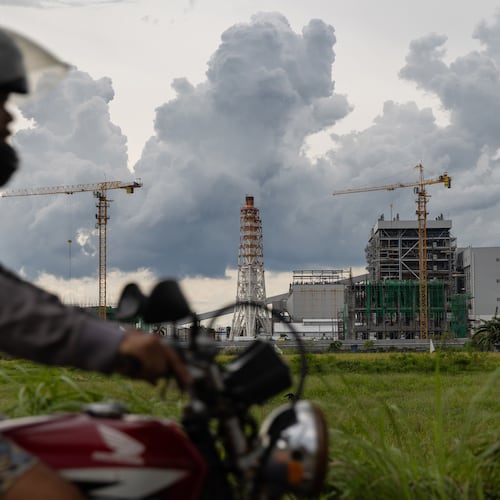FILE - A motorcyclist drives past the South Luzon Thermal Energy Power Plant in Calaca, Batangas, in the Philippines on Oct. 4, 2025. (AP Photo/Anton L. Delgado, File)