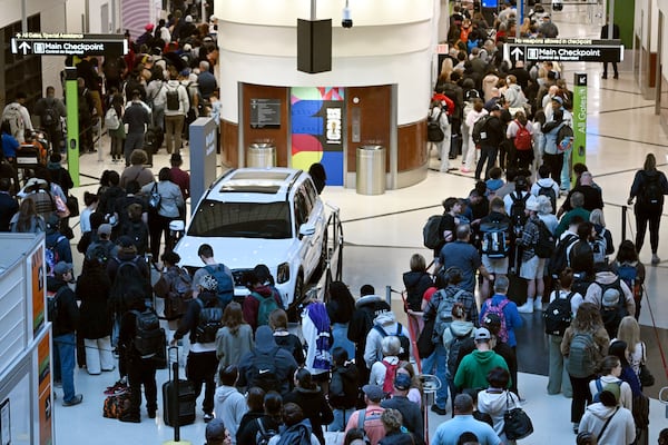 Air travelers endure long lines and two-hour wait times at the TSA security checkpoint at Hartsfield-Jackson Atlanta International Airport amid the partial government shutdown on Saturday, March 21, 2026, in Atlanta. (Hyosub Shin/AJC)