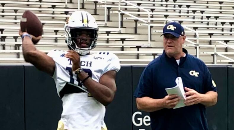Georgia Tech quarterbacks coach Chris Weinke watches quarterback Jeff Sims warm up at the start of the team's Aug. 24, 2022 practice at Bobby Dodd Stadium. (AJC photo by Ken Sugiura)