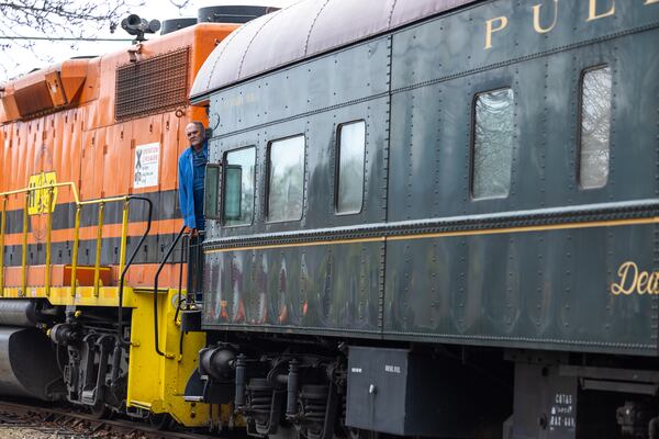 A person stands on the SAM Shortline excursion train in downtown Plains on Saturday, February 25, 2023. (Arvin Temkar / arvin.temkar@ajc.com)