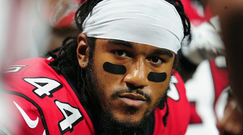 Vic Beasley of the Falcons sits on the sideline during the first half against the Packers Sunday in Atlanta's Mercedes-Benz Stadium.