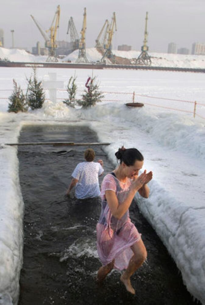 Think it's cold? Russians plunge into ice bath