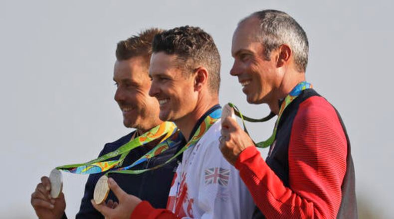 The medalists are seen from left to right, silver medalist Henrik Stenson of Sweden, gold medalist Justin Rose of Great Britain, and bronze medalist Matt Kuchar of the, United States, after the final round of the men's golf event at the 2016 Summer Olympics in Rio de Janeiro, Brazil, Sunday, Aug. 14, 2016. (AP Photo/Chris Carlson)