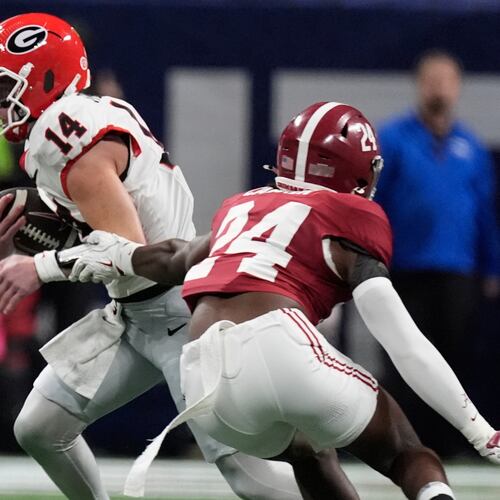 Georgia quarterback Gunner Stockton runs against Alabama linebacker Noah Carter during the first half of a Southeastern Conference championship NCAA college football game, Saturday, Dec. 6, 2025, in Atlanta. (Mike Stewart/AP)