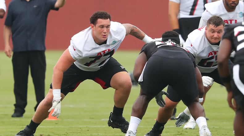 073021 Flowery Branch: Atlanta Falcons offensive lineman Jalen Mayfield (left), the team's third round draft pick, gets in some work next to Chris Lindstrom the second day of training camp practice at the team training facility on Friday, July 30, 2021, in Flowery Branch.   “Curtis Compton / Curtis.Compton@ajc.com”