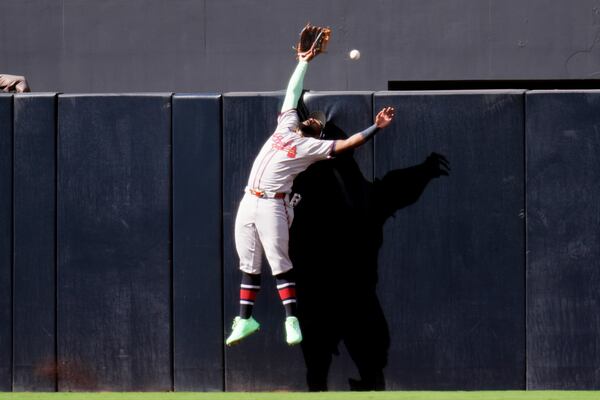Braves centerfielder Michael Harris II can't reach a seventh-inning home run hit by the Padres' Gavin Sheets.