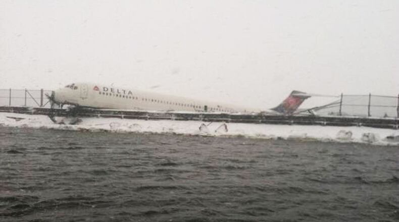 Delta Air Lines Flight 1086 is seen after it slid off the runway upon landing at New York's LaGuardia Airport March 5, 2015. The Delta Air Lines jetliner landing during a snowstorm at New York's LaGuardia Airport on Thursday slid off the runway and struck a fence before coming to rest at the edge of Flushing Bay, but there were no serious injuries.