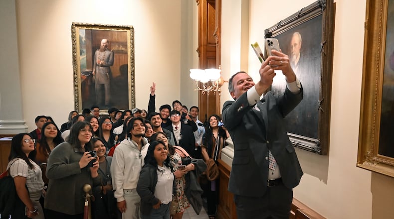 State Sen. Drew Echols (right) takes a selfie with Latino students and children as they visit the Georgia state Capitol in 2025. Latinos are 16% of Georgia’s K-12 students. (Hyosub Shin/AJC)