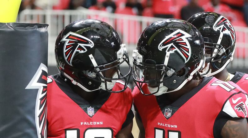 September 16, 2018 Atlanta: Falcons wide receiver Calvin Ridley gets a helmet bump from Julio Jones after his first NFL touchdown against the Panthers in a NFL football game on Sunday, Sept 16, 2018, in Atlanta. Curtis Compton/ccompton@ajc.com