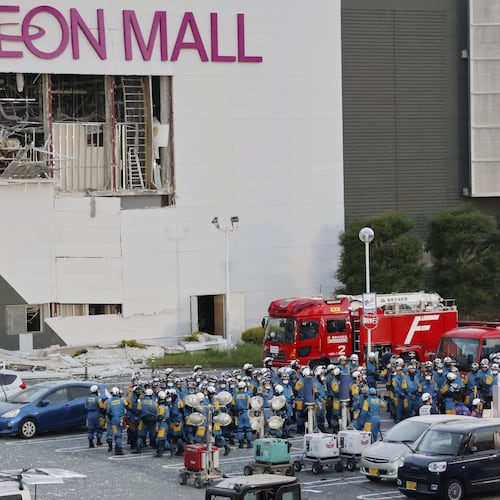 Police units gather in the parking lot before beginning operations at Aeon Mall Kumamoto in Kashima, Kumamoto Prefecture, Friday, July 31, 2026. (Kyodo News via AP)