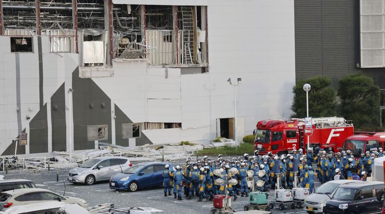 Police units gather in the parking lot before beginning operations at Aeon Mall Kumamoto in Kashima, Kumamoto Prefecture, Friday, July 31, 2026. (Kyodo News via AP)