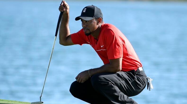 FILE - In this Dec. 4, 2016, file photo, Tiger Woods lines up a putt on the 17th hole during the final round of the Hero World Challenge golf tournament in Nassau, Bahamas.  A new year starts with an old topic, with a twist. Instead of wondering when Tiger Woods will play, the question now is how will he play?  (AP Photo/Lynne Sladky, File)