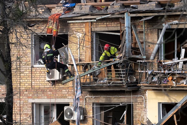 Rescue workers clear the rubble from a house heavily damaged after a Russian strike in a residential neighborhood in Kyiv, Ukraine, Thursday, April 24, 2025. (AP Photo/Alex Babenko)