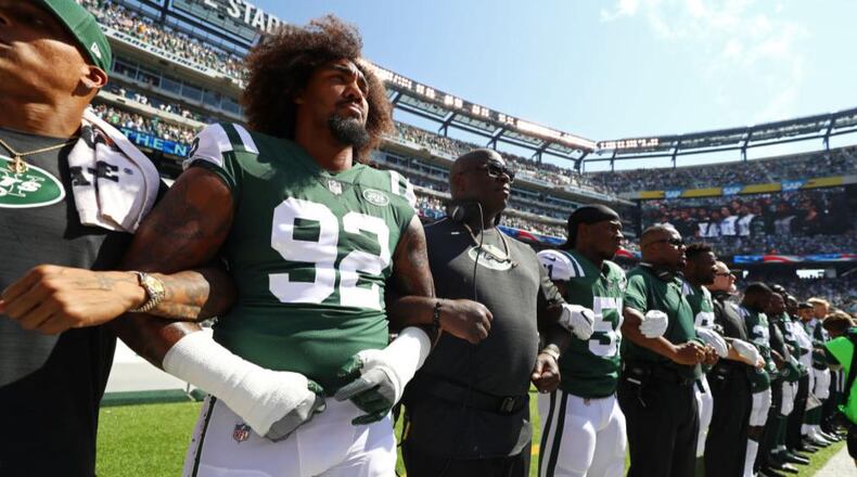 Leonard Williams #92 of the New York Jets stands in unison with his team during the National Anthem prior to an NFL game against the Miami Dolphins at MetLife Stadium on September 24, 2017 in East Rutherford, New Jersey.  (Photo by Al Bello/Getty Images)