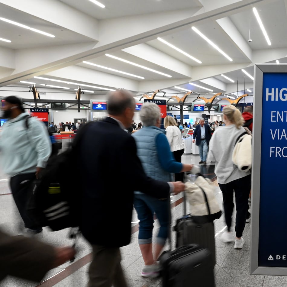 Early morning travelers wait in long lines extending to the baggage claim area as they wait to get through security screening at Hartsfield-Jackson Atlanta International Airport amid the partial government shutdown on Saturday, March 21, 2026, in Atlanta. (Hyosub Shin/AJC)