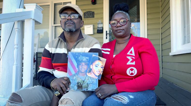Oneida Oliver-Sanders (Right) and Shawn Sanders hold a photograph of their daughter, Spc. Kennedy Ladon Sanders at their Waycross GA home Tuesday, January. 30, 2024. (Joe Kovac/ Joe.Kovac@ajc.com)