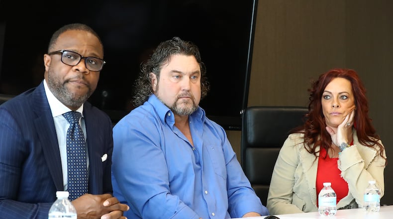 Attorney Shean Williams (from left), Noel Hall and his wife Christie speak to reporters in March 2020. Hall was shot by an Atlanta police officer in 2017 as he drove his car away from the officer during a traffic dispute. The city council voted Monday to settle the North Carolina man's lawsuit for $990,000.