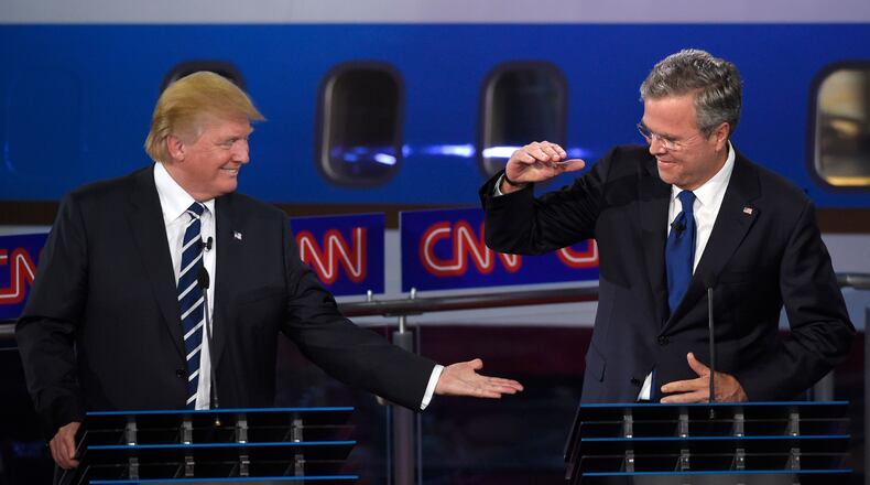 Republican presidential candidate, businessman Donald Trump, left, and Jeb Bush slap hands near the finish of the CNN Republican presidential debate at the Ronald Reagan Presidential Library and Museum on Wednesday, Sept. 16, 2015, in Simi Valley, Calif. (AP Photo/Mark J. Terrill)