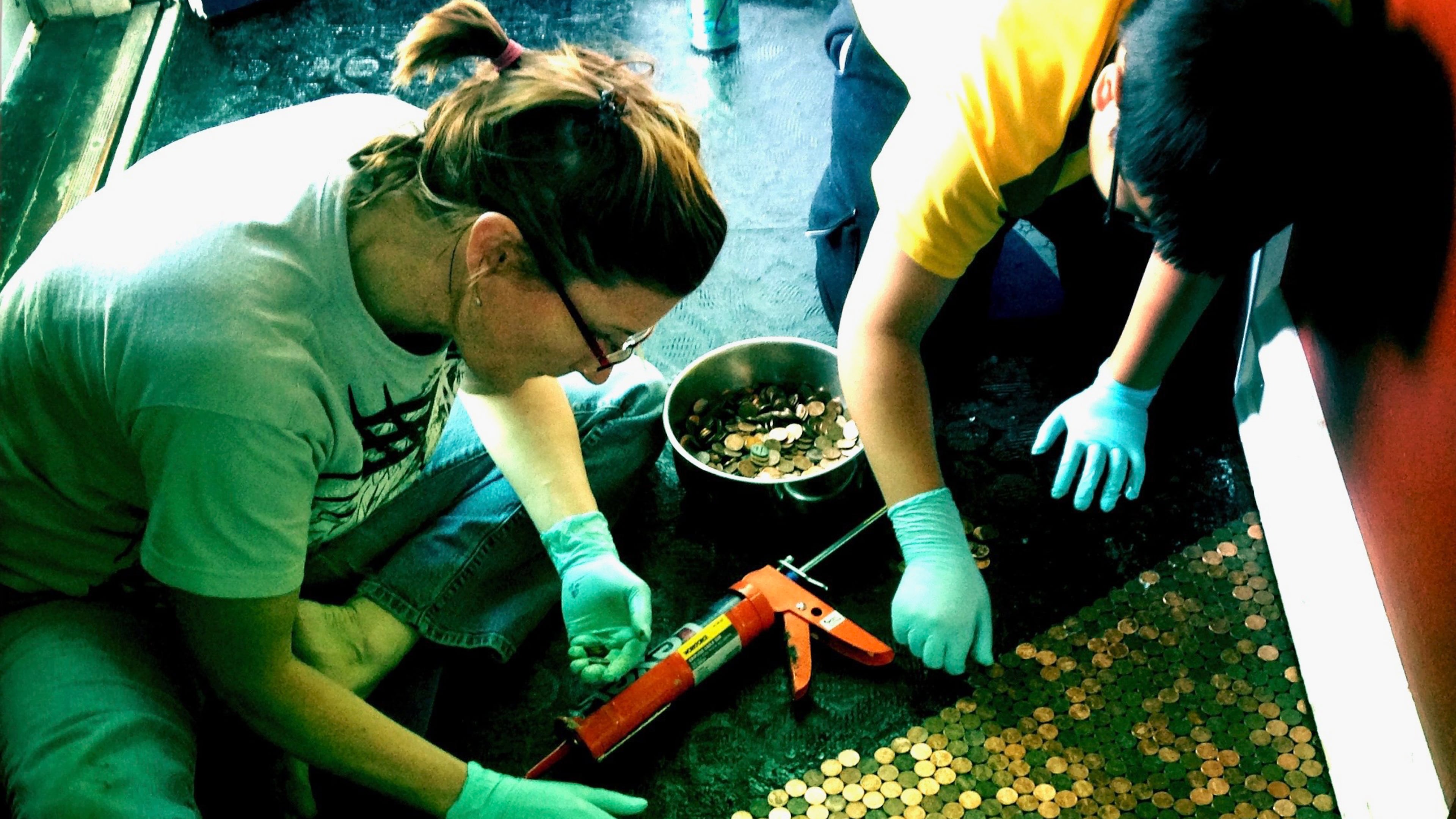 Karas Cahill decided to do something with her vast jar of pennies. So she and her son, Angelo, over the course of a couple weeks, glued 10,738 to the floor of her front hallway. (Courtesy of Karas Cahill)