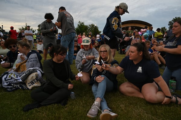 Community members and leaders come together during a 2024 candlelight vigil at Jug Tavern Park in Winder following a deadly shooting at Apalachee High School. (Hyosub Shin/AJC)